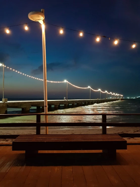 benches on the boardwalk with a city in the background