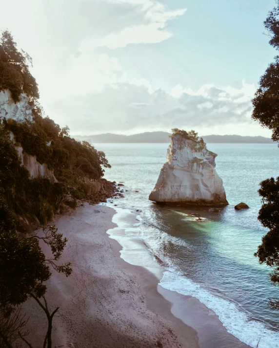 a beach that has rocks in it next to the water