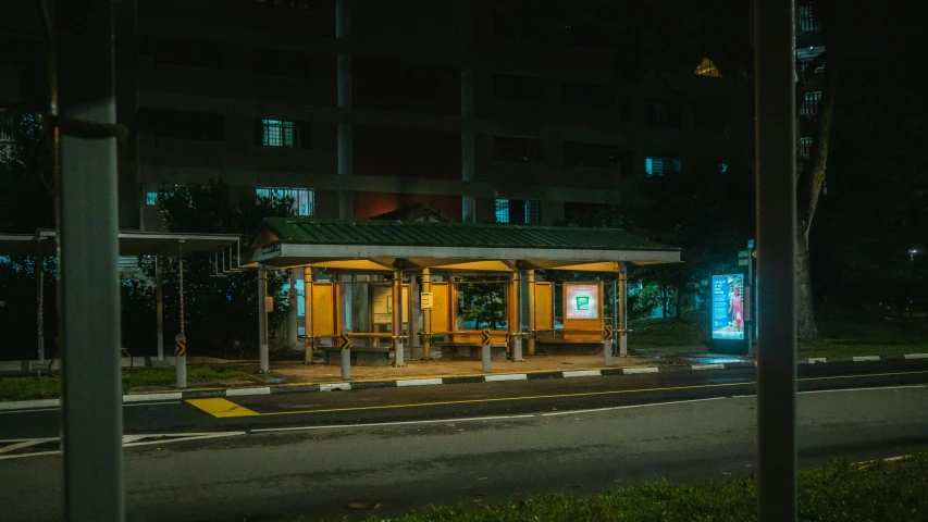 a small covered bus stop in the middle of a town
