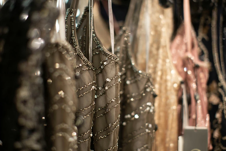 various colors of dresses on racks in a store