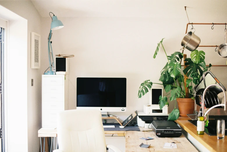 a work desk with laptop and computer monitor on top of it