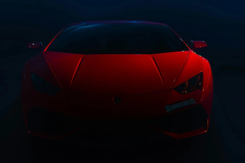 this is a red sports car in the dark