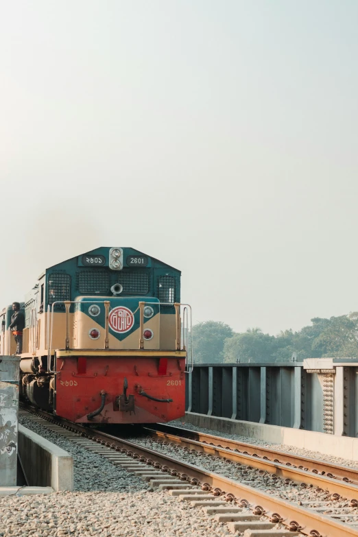 an old train pulling three cars down some railroad tracks