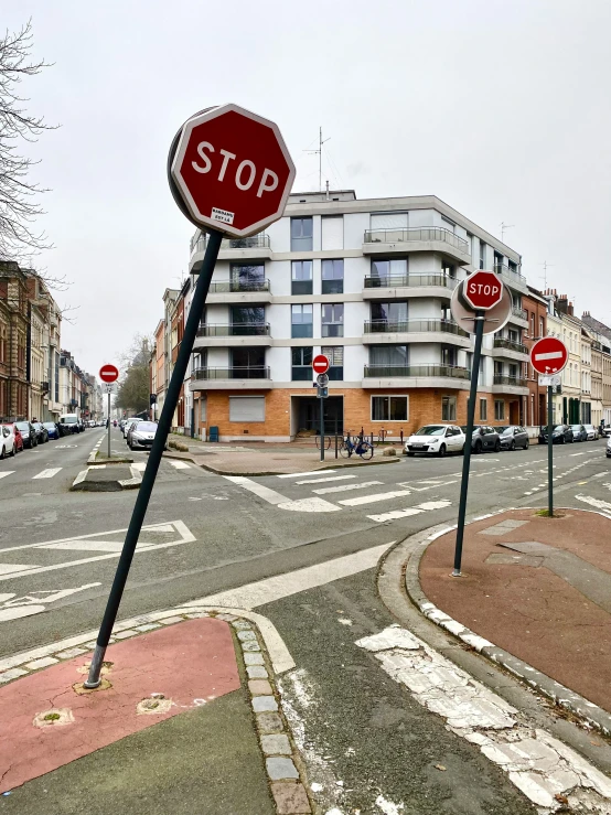 a stop sign is bent in the air on a street corner