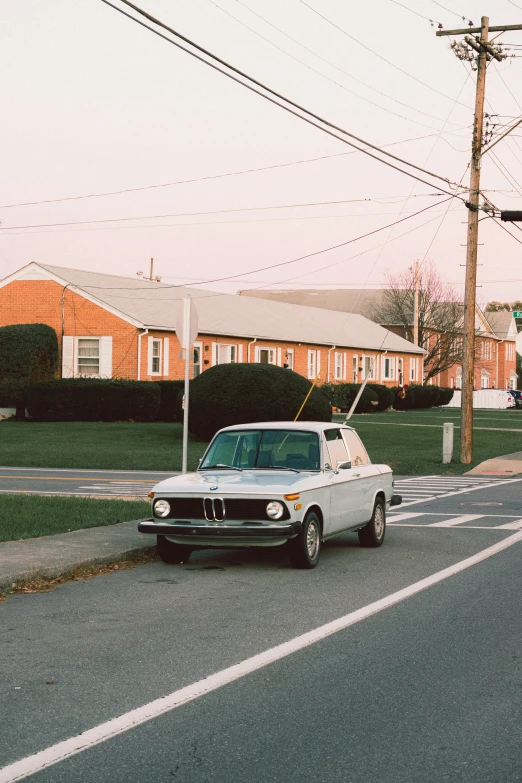 an old white truck is driving through the town