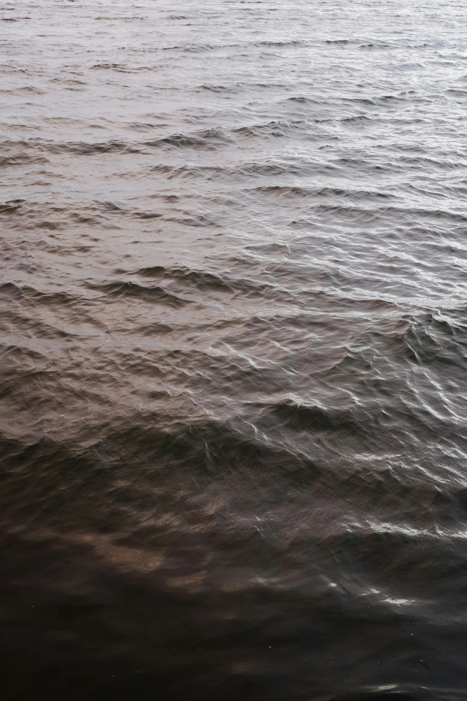 a lone boat floating on top of water