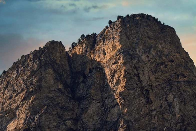 three very large rocks with a plane in the sky above them