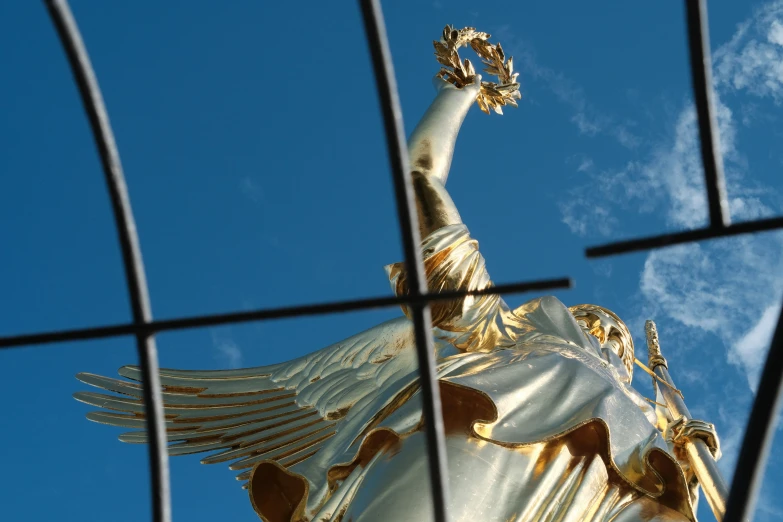 a view of the statue of liberty behind a fence