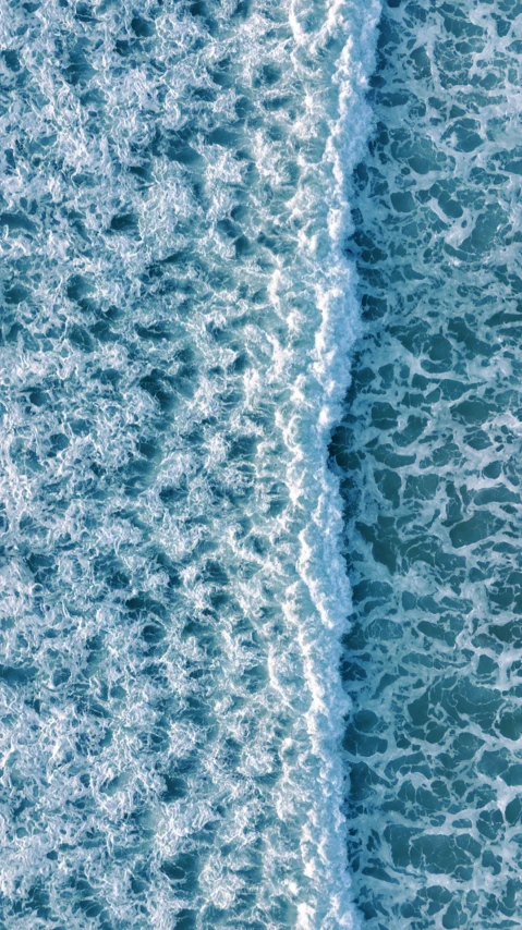 the waves roll towards the shore with foamy waves