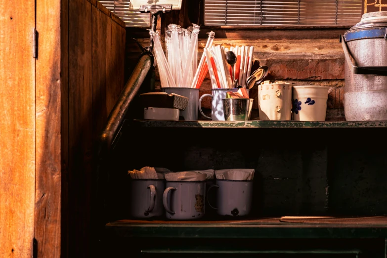 several pots and containers are stacked on top of a table