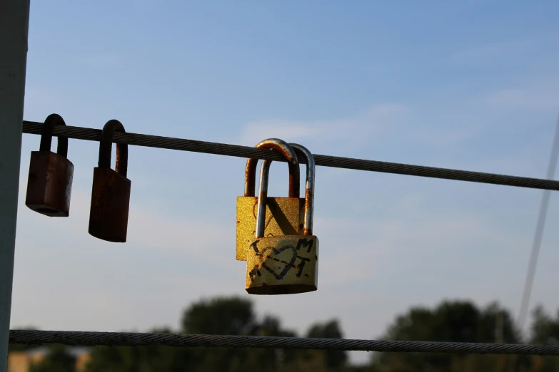 a couple of locks on a metal fence