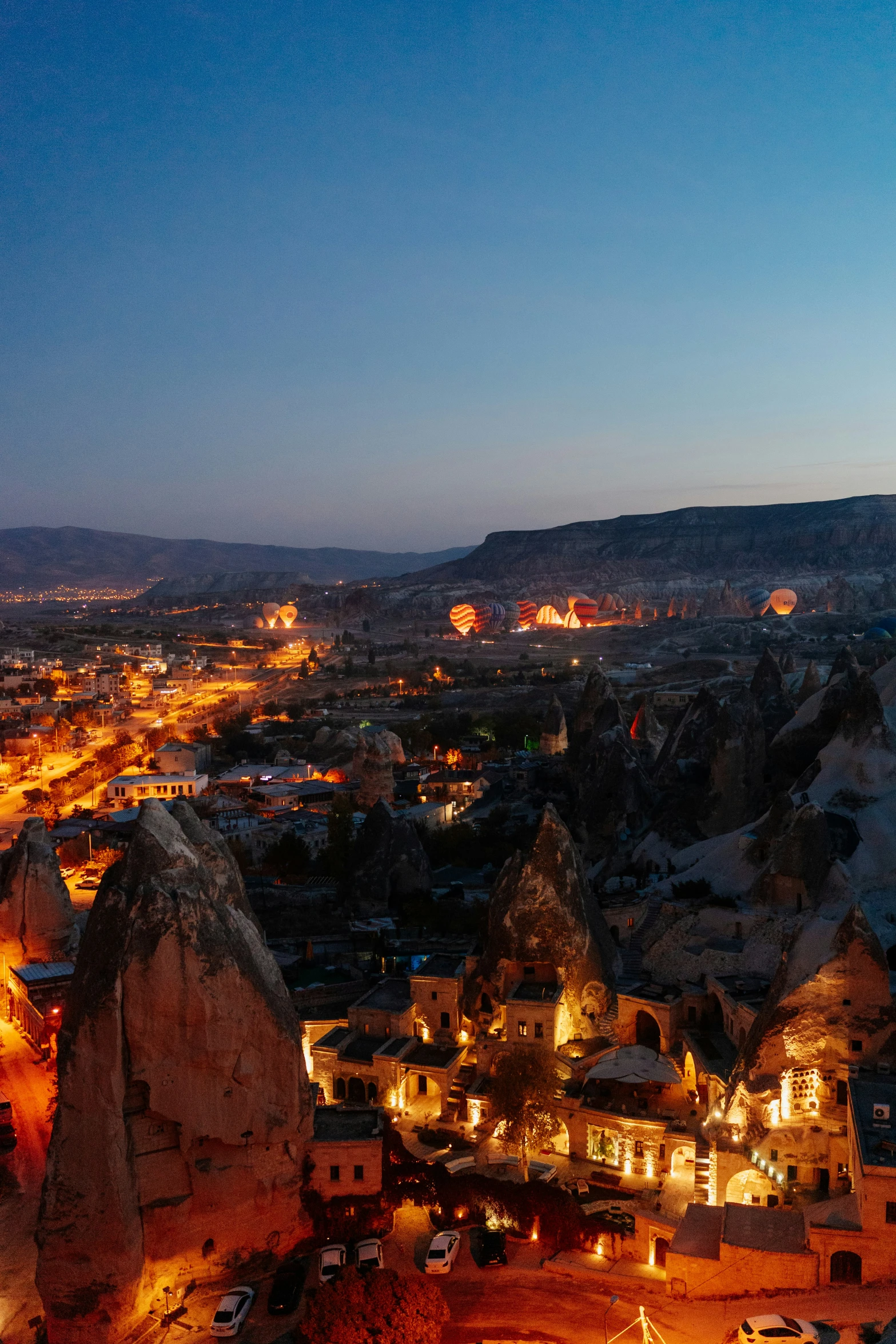 view from high above of an area with rock formations and lit buildings