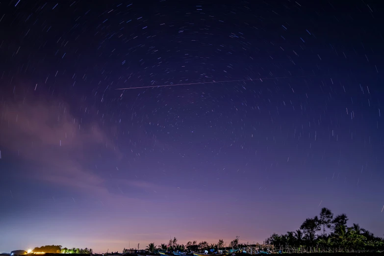 the night sky with stars above an island and other structures