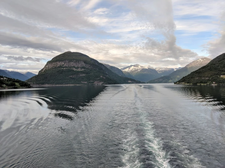 mountains, a lake and some water are in the distance