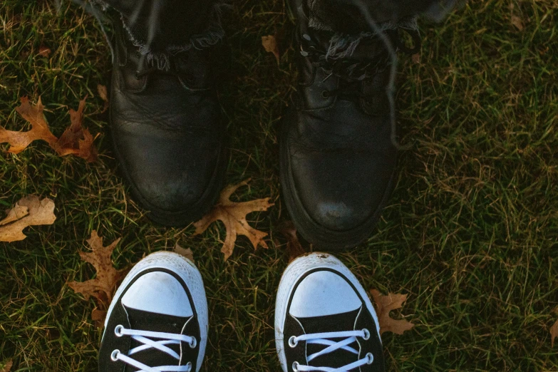 a black and white shoe is placed on the grass