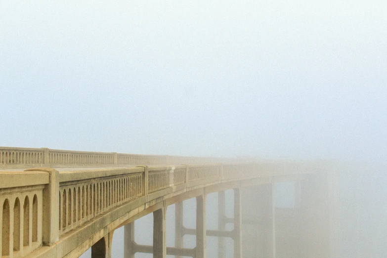 a long bridge and some people riding a boat