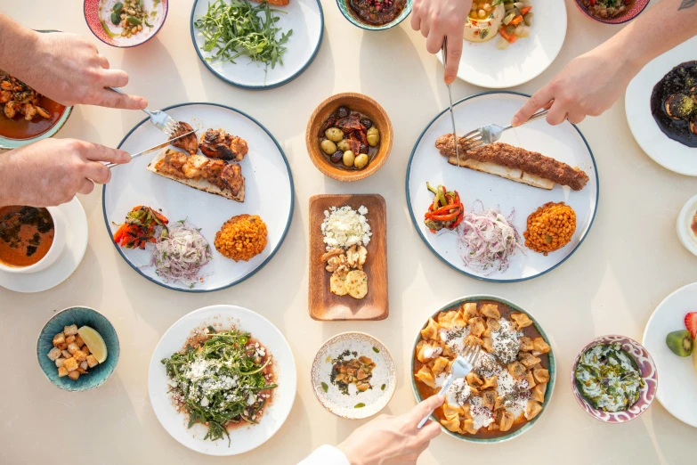 people gathered around the dining table having a lot of food