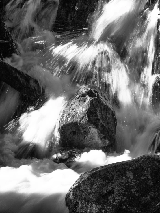 a water fall with the cascades falling off and creating small bubbles