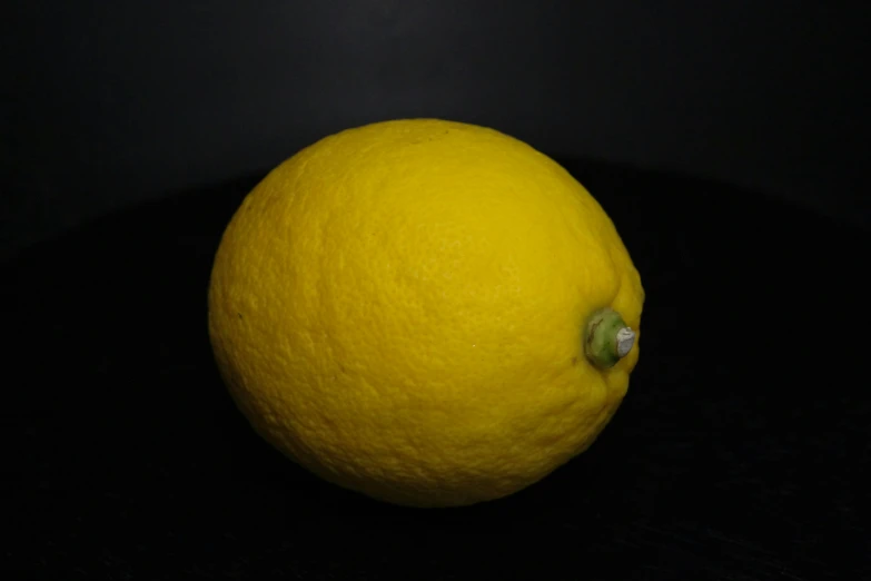 the dark side of a yellow fruit that is still intact