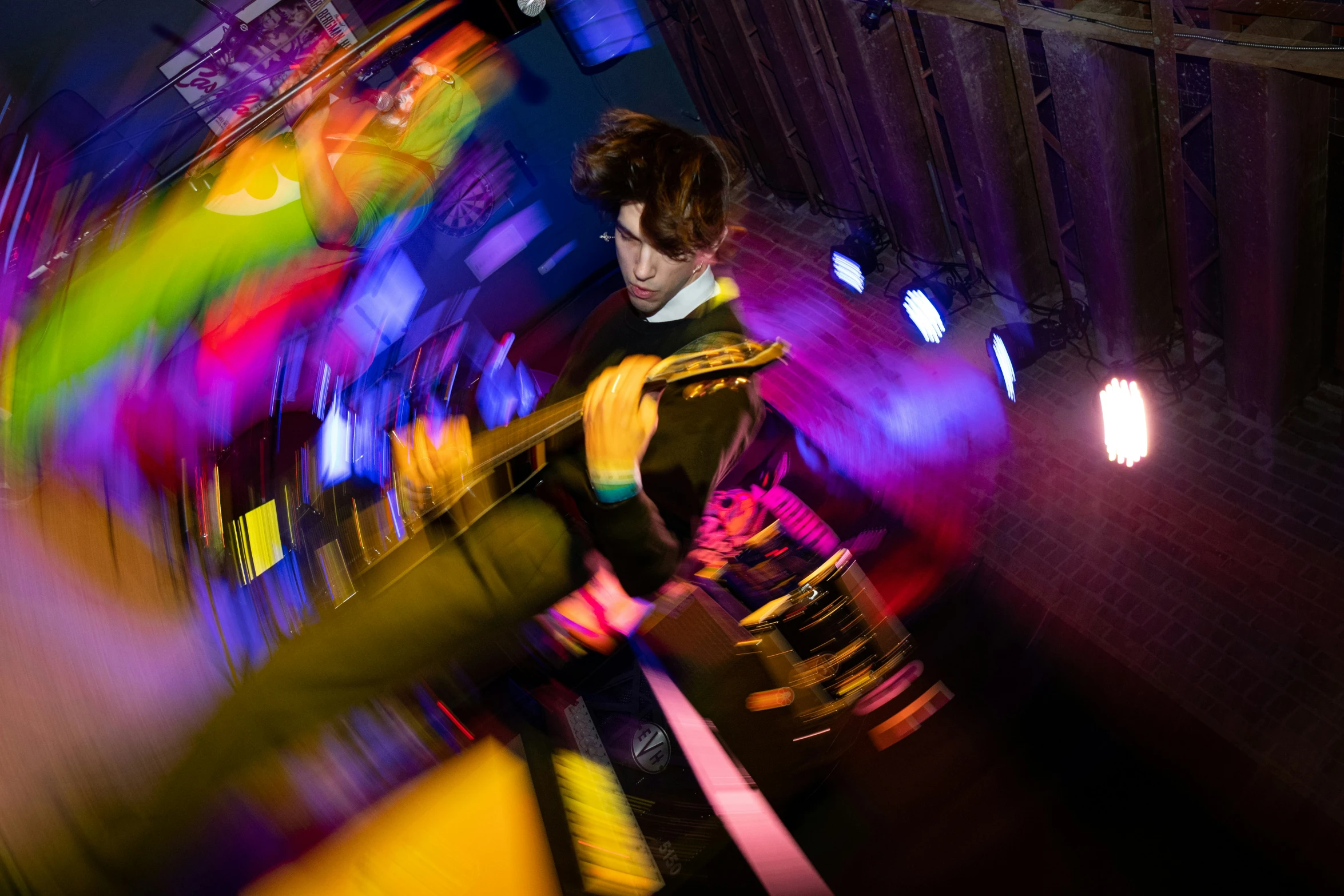 a colorful blurry image of a man standing by a fire hydrant