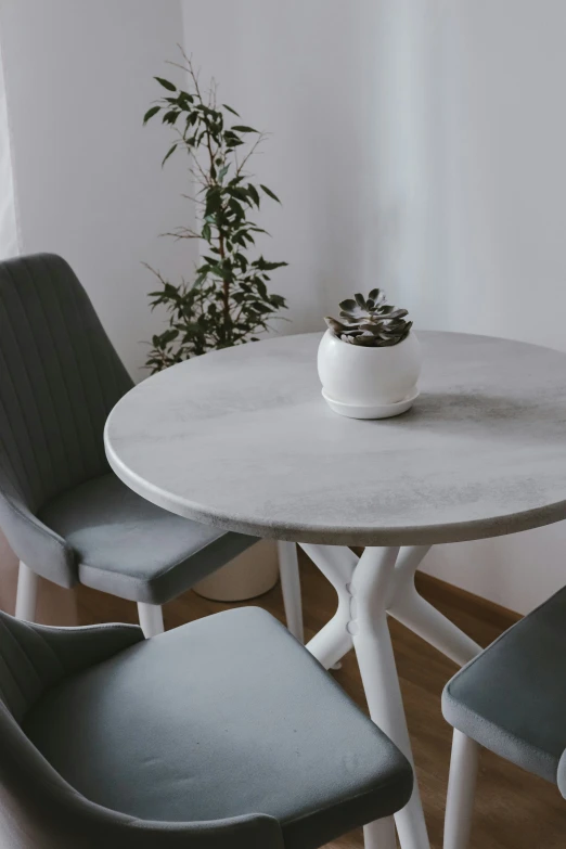 this dining room table has two chairs and a round white table