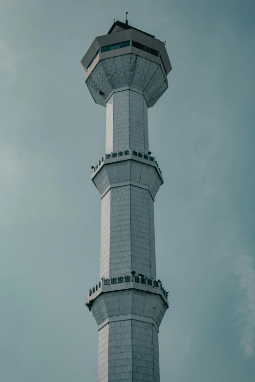 a tall tower with a top of six with writing on the sides