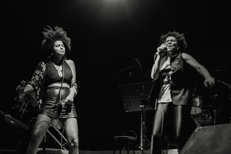 two women that are on stage singing