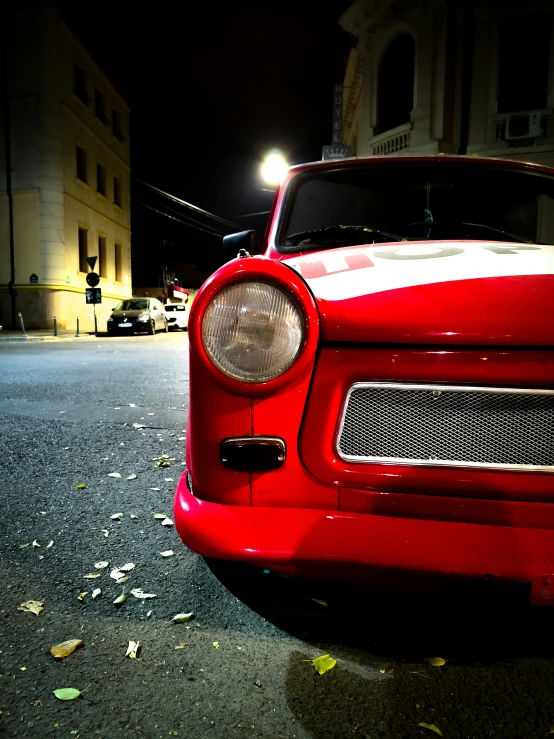 a red car parked next to the side of a street