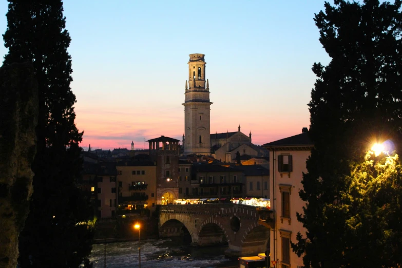 a clock tower towering over the city of bologna, italy