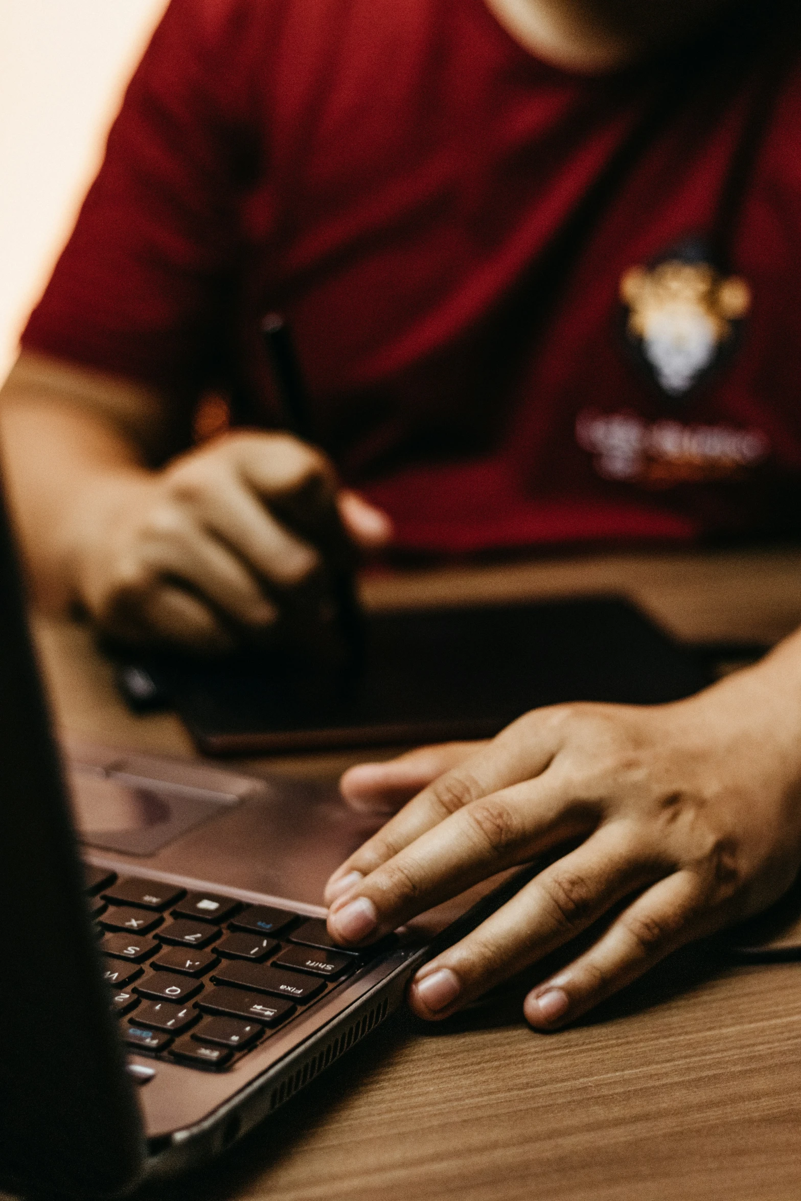 a hand on a keyboard of a laptop computer