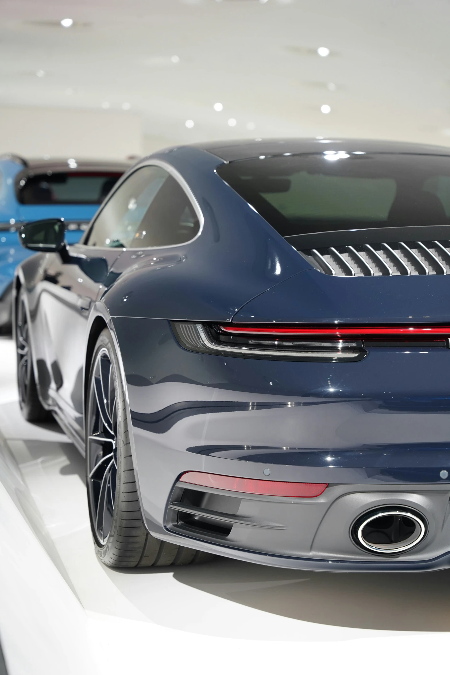 a close up view of a gray sports car on display