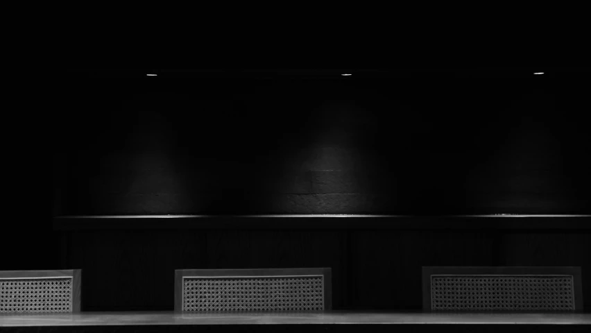 a group of speakers sitting on top of a set of stage