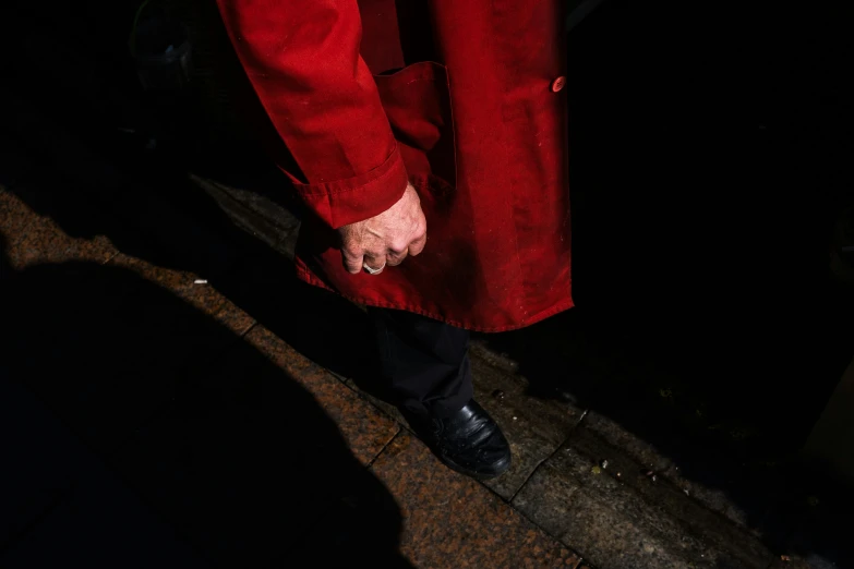 a person in a red suit and silver chain