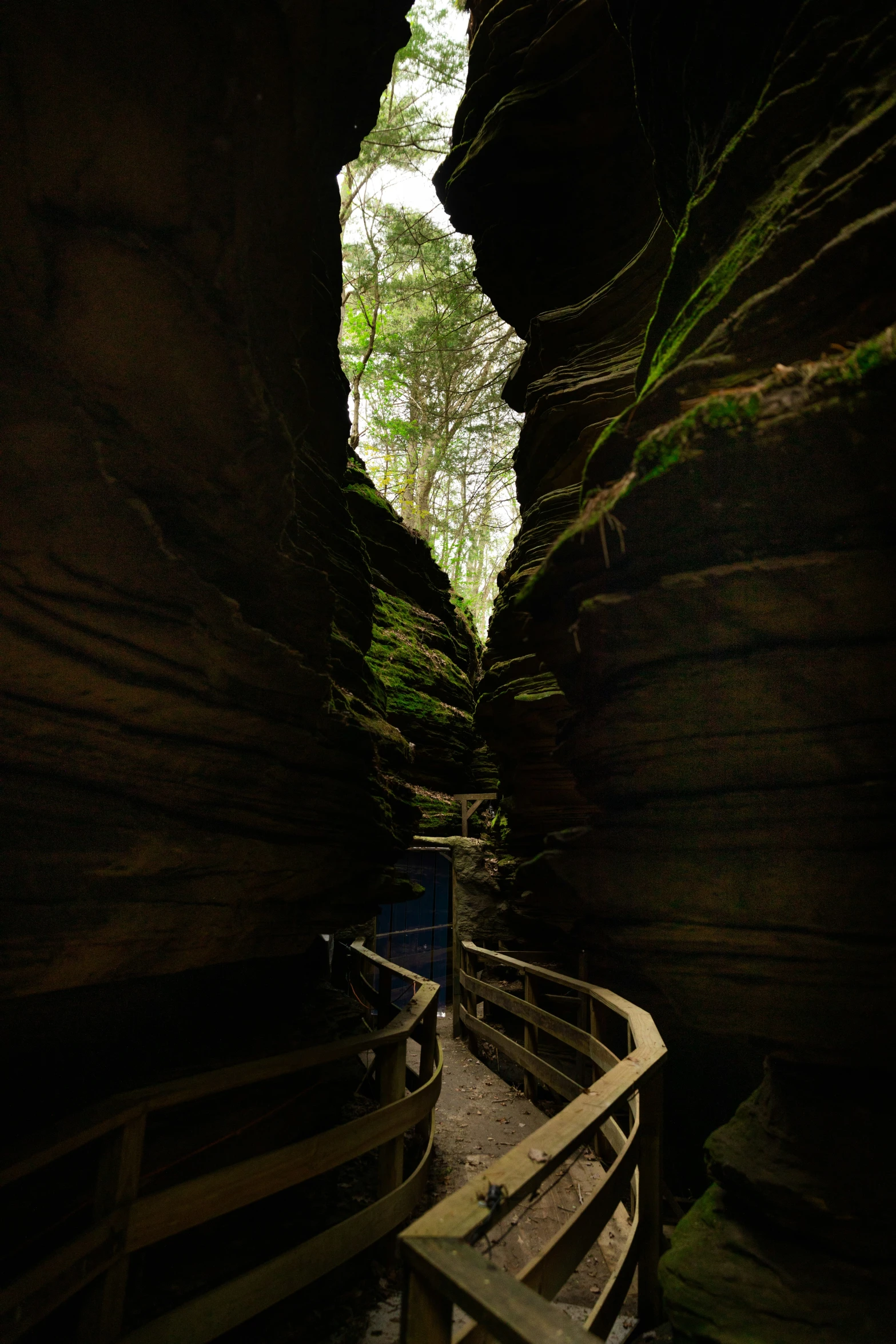 an empty stone tunnel with a light at the end