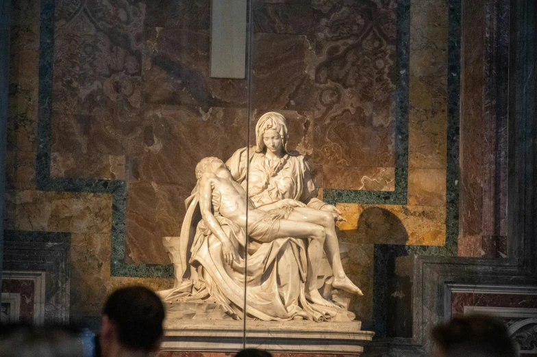 a woman sits in front of the statues of the sisecoas and other figures