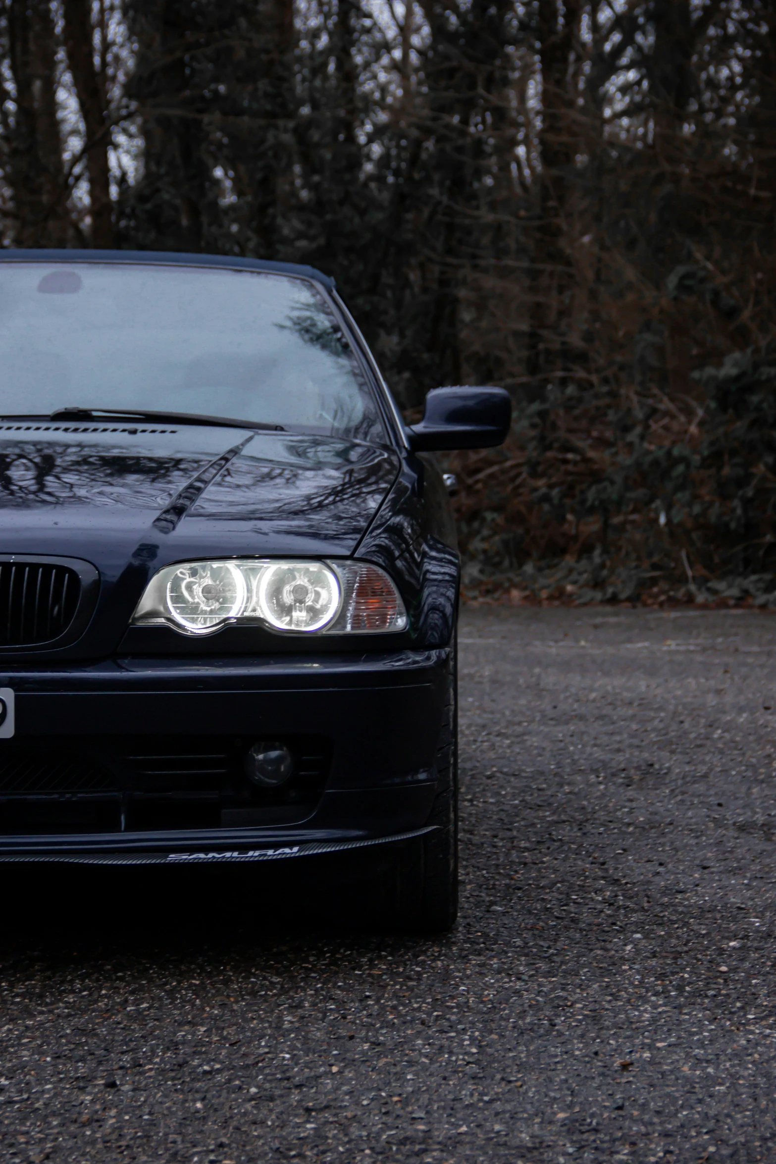 the front of an automobile is parked in the street