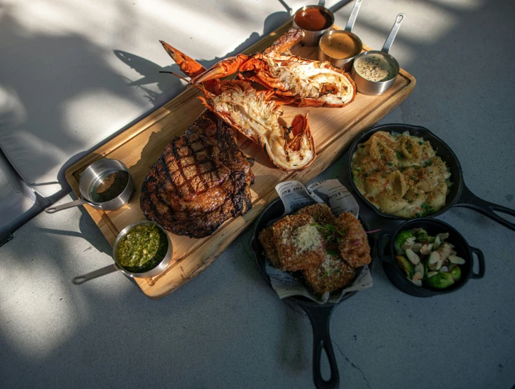 a plate of steak and sides on a tray