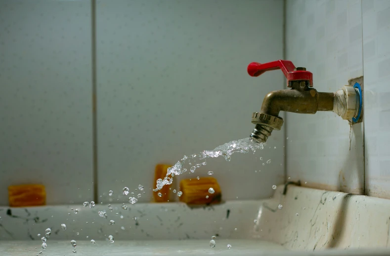 a spout of water shooting up from a faucet