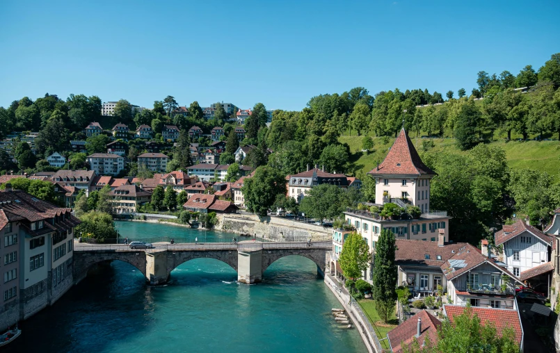 an old river runs through the town below a bridge