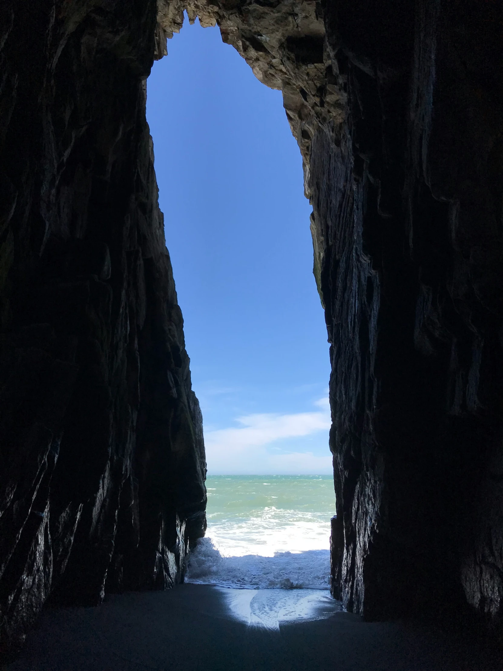 an ocean cave at night with water moving underneath