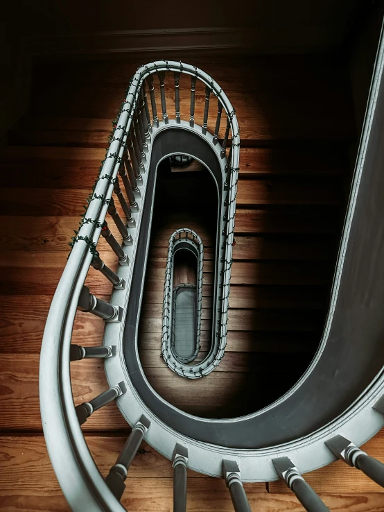 a spiral staircase with a black railing on the top of it