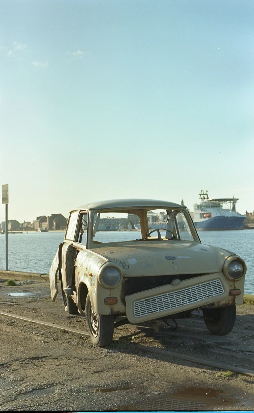 an old dirty, run down truck by the water