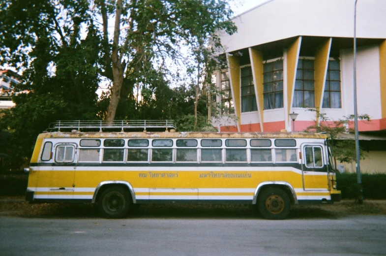 a old yellow bus parked on the street