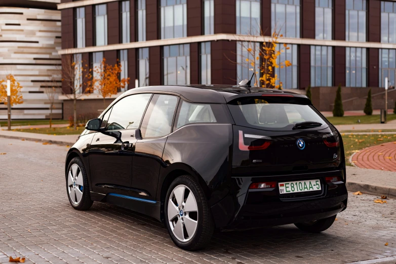 the new electric car is parked on a cobblestone street