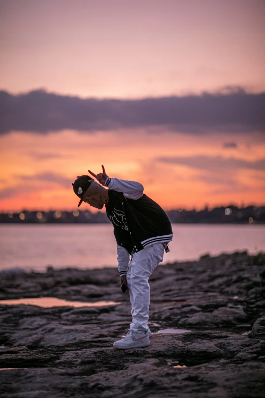 the man is standing on a beach watching the ocean