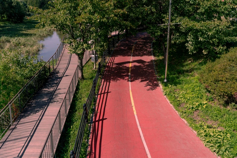 an athletic court with a bridge leading to trees