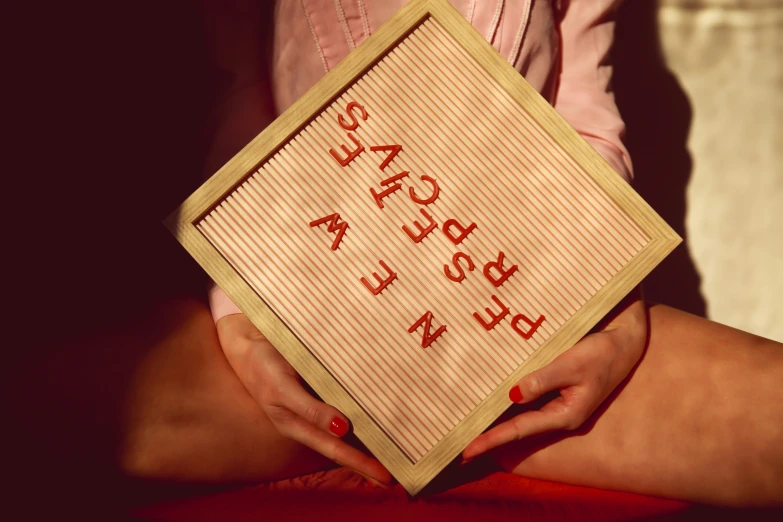 a woman is holding a little sign with the words welcome back