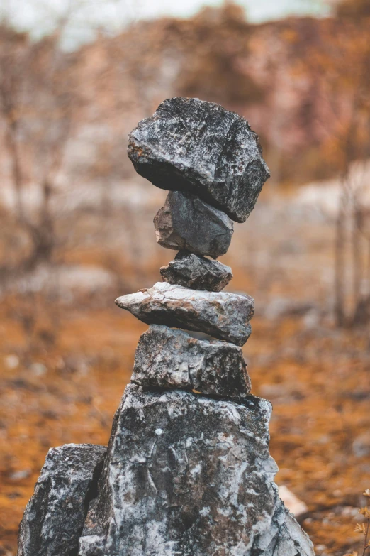 a small pile of rocks sitting in the middle of a field