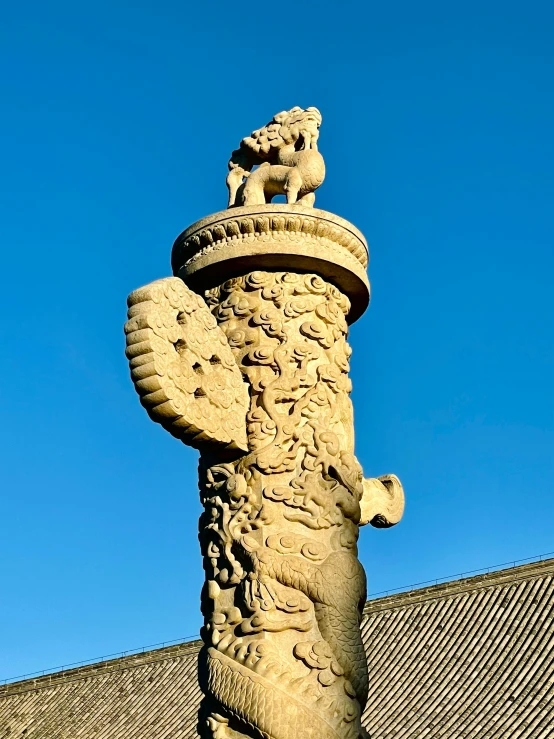 a gargoyle statue stands in front of a building