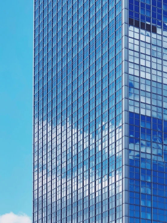 a plane flying in the sky near a tall building